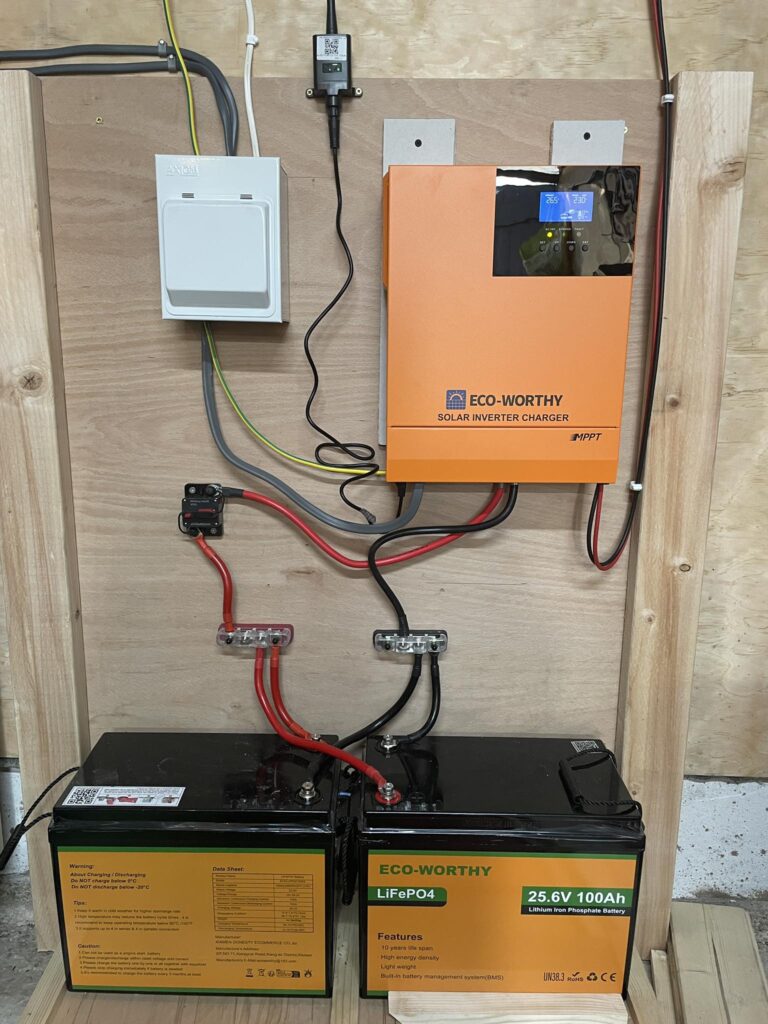 24V inverter mounted on off-grid cabin power wall